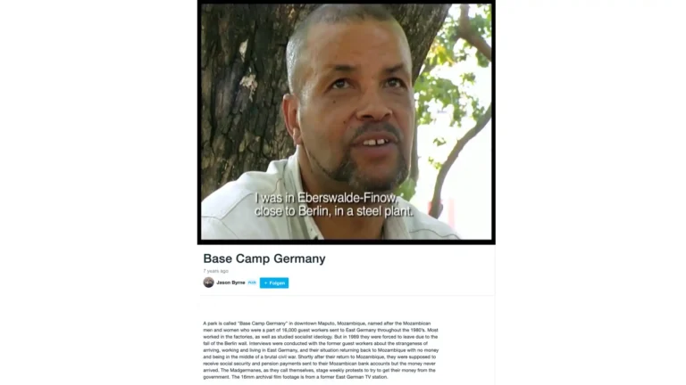 Bildschirmfoto der Filmseite „Base Camp Germany“ von Jason Byrne: Arnaldo Soares Mendes im Interview, Untertitel „I was in Eberswalde-Finow, close to Berlin, in a steel plant.“